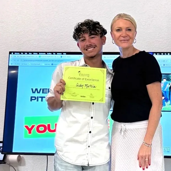 Lenka Brady with student Aiden Mattia holding Certificate of Excellence